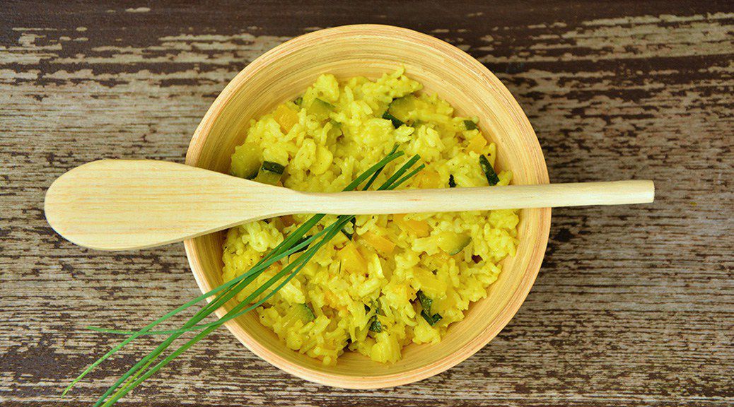 Bowl of rice with a wooden spoon